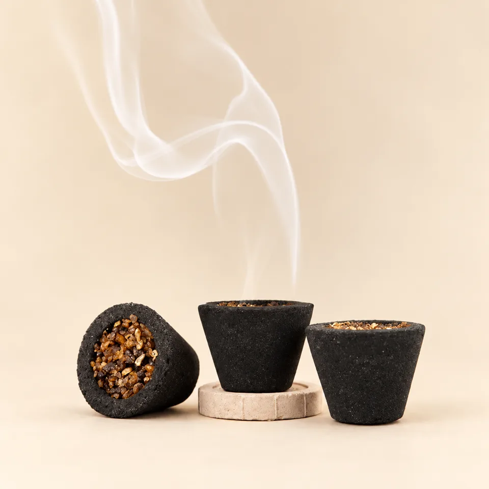 Black Sambhrani dhoop cups against an ivory background — styled product image